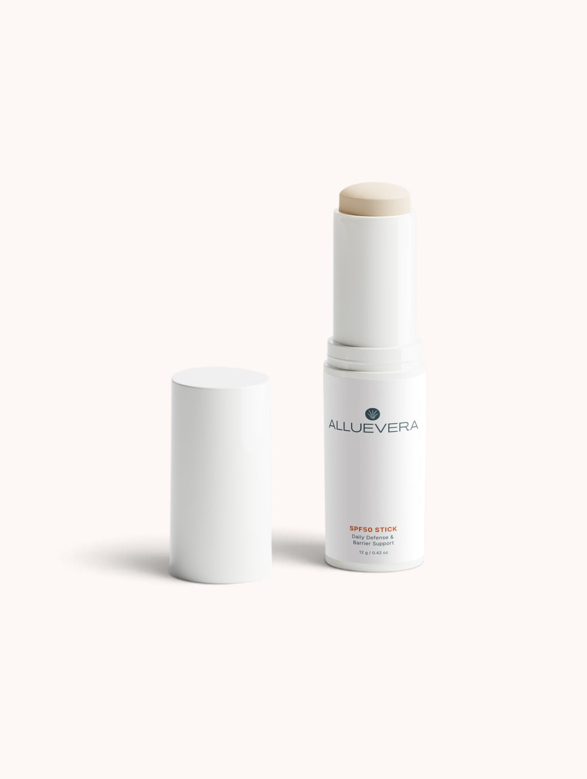 Alluevera SPF 30 Stick in a white cylindrical tube with its cap removed, showing the beige-tan sunscreen stick tip, on a clean off-white background.